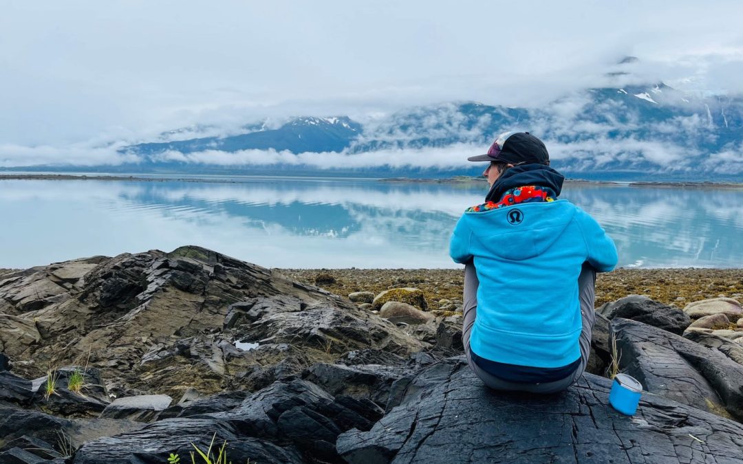 Jennifer England sitting on a rock in Alaska